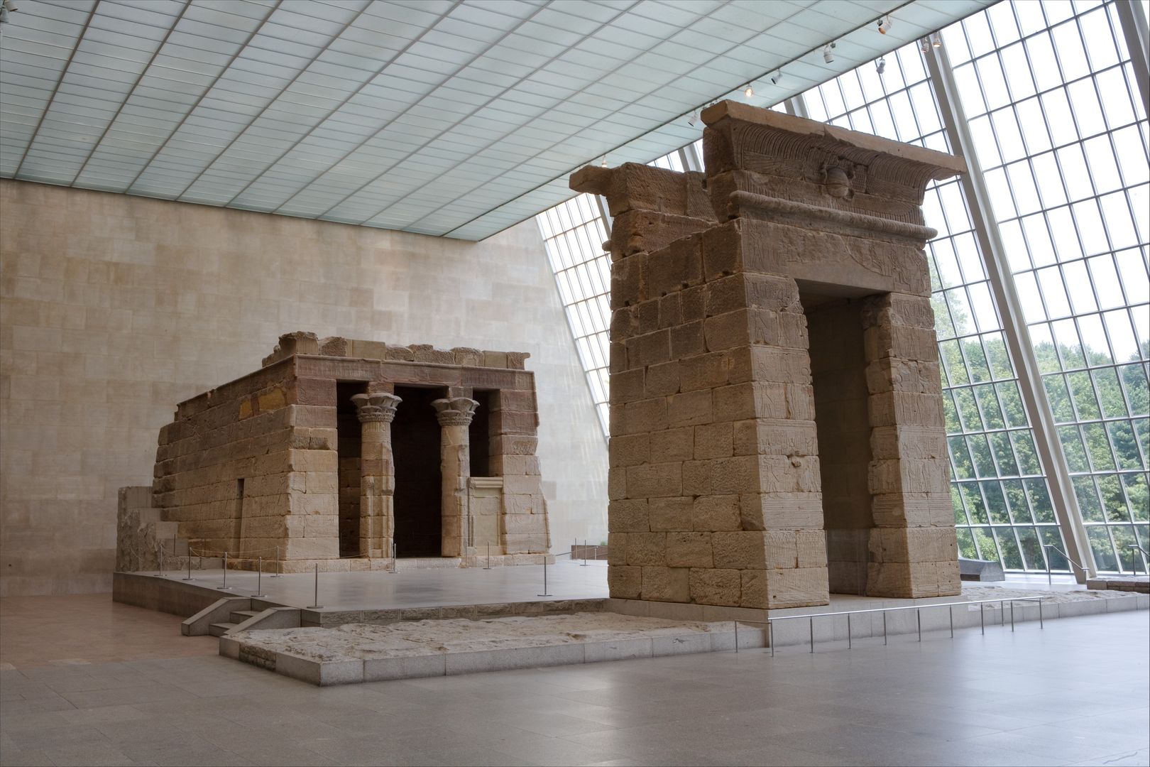 An Egyptian temple stands in a glass-paneled room. (The Temple of Dendur)